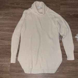 Sweater with a slight turtle neck. never worn. Perfect for fall weather.